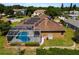 Rear exterior showcasing a beautiful screened-in pool and solar panels at 887 Lancer Cir, Ocoee, FL 34761