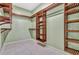 Custom walk-in closet with tile floor and wooden shelving at 887 Lancer Cir, Ocoee, FL 34761