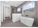 Sleek bathroom featuring a freestanding tub, walk-in shower, and modern fixtures at 9265 Eagles Perch Pl, Orlando, FL 32825