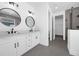Elegant bathroom with double vanity, marble countertops, and a walk-in shower with glass door at 9265 Eagles Perch Pl, Orlando, FL 32825