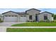 Beautiful single Gathering home featuring a lush lawn, brick facade, and a two car garage at 9265 Eagles Perch Pl, Orlando, FL 32825