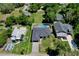 Aerial view of the property showcasing its well-maintained landscaping, sparkling pool, and proximity to neighboring homes at 934 Jessamy St, Oviedo, FL 32765