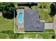 Aerial view of the property showcasing its well-maintained landscaping, sparkling pool, and proximity to neighboring homes at 934 Jessamy St, Oviedo, FL 32765