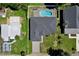 Aerial view of the property showcasing its well-maintained landscaping, sparkling pool, and proximity to neighboring homes at 934 Jessamy St, Oviedo, FL 32765