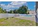 A backyard featuring an outdoor kitchen, fire pit and pool all contained by a white vinyl fence at 934 Jessamy St, Oviedo, FL 32765