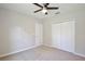 Bedroom with carpet, ceiling fan, closet, and door at 934 Jessamy St, Oviedo, FL 32765