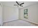 Bedroom features a ceiling fan, carpet, and a window overlooking the yard at 934 Jessamy St, Oviedo, FL 32765