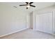 Spacious bedroom with carpet, ceiling fan, closet, and door at 934 Jessamy St, Oviedo, FL 32765