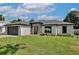 Charming single-story home with lush green lawn, stone accents, and a dark-colored two car garage at 934 Jessamy St, Oviedo, FL 32765