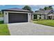 Charming single-story home with lush green lawn, stone accents, and a dark-colored two car garage at 934 Jessamy St, Oviedo, FL 32765