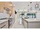 Spacious kitchen features stainless appliances, a quartz island, and an open floor plan at 934 Jessamy St, Oviedo, FL 32765