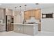 Modern kitchen with stainless steel appliances, island with bar seating, and wood accents at 934 Jessamy St, Oviedo, FL 32765