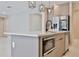 Close-up of a modern kitchen island with a microwave and stainless steel appliances at 934 Jessamy St, Oviedo, FL 32765