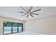View of a simple living room with white walls and modern lighting fixtures with large glass doors to a pool at 934 Jessamy St, Oviedo, FL 32765