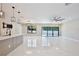 Bright and airy living space with modern lighting, sleek floors, and sliding glass doors to the pool at 934 Jessamy St, Oviedo, FL 32765