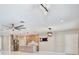 Open-concept living area with modern kitchen featuring stainless steel appliances and white tiled floors at 934 Jessamy St, Oviedo, FL 32765