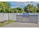 Outdoor kitchen featuring stainless steel grill, granite counters, tile backsplash, and a stone fire pit at 934 Jessamy St, Oviedo, FL 32765