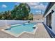 Backyard view of a refreshing pool surrounded by a gray brick paver patio and a well manicured lawn at 934 Jessamy St, Oviedo, FL 32765