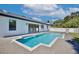 Backyard view of a refreshing pool surrounded by a gray brick paver patio and a well manicured lawn at 934 Jessamy St, Oviedo, FL 32765