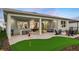 Spacious backyard featuring putting green, covered patio with outdoor dining and lounge area at 960 Club Cresswind Dr, Lady Lake, FL 32159