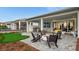 Inviting backyard with putting green, covered patio, firepit, and outdoor seating area at 960 Club Cresswind Dr, Lady Lake, FL 32159