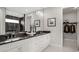 Elegant bathroom featuring double vanity with black countertops, and a view into the glass enclosed shower at 960 Club Cresswind Dr, Lady Lake, FL 32159