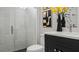 Modern bathroom featuring a textured-tile shower, black vanity, and decorative vase at 960 Club Cresswind Dr, Lady Lake, FL 32159