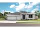 Charming single-story home featuring a two-car garage, a covered entry, and lush landscaping at 960 Club Cresswind Dr, Lady Lake, FL 32159