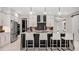 Elegant kitchen featuring a waterfall island, sleek white cabinetry, and stainless steel appliances at 960 Club Cresswind Dr, Lady Lake, FL 32159