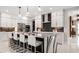 Modern kitchen boasting a waterfall island, bar seating, white cabinets, and stainless steel appliances at 960 Club Cresswind Dr, Lady Lake, FL 32159