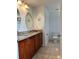 Bathroom featuring dual sinks, granite countertops, updated fixtures, and ample lighting at 112 Tulip Ln, Kissimmee, FL 34759