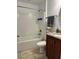 Well-lit bathroom with a shower-tub combo, updated fixtures, and granite countertops at 112 Tulip Ln, Kissimmee, FL 34759