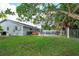 Spacious backyard with a fenced pool, hot tub, and lush green lawn, ideal for outdoor enjoyment at 11435 Aries Dr, Orlando, FL 32837