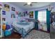 Eclectic bedroom featuring colorful art, unique decor, and a cozy bed with patterned bedding at 11435 Aries Dr, Orlando, FL 32837