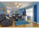 Comfortable living room with a ceiling fan, sliding doors, and a blue accent wall at 11435 Aries Dr, Orlando, FL 32837
