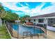 Backyard pool and hot tub with a safety fence, offering relaxation and Gathering fun at 11435 Aries Dr, Orlando, FL 32837