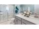 Elegant bathroom featuring double sinks, a glass-enclosed shower, and stylish fixtures at 1217 Reunion Village Blvd, Kissimmee, FL 34746