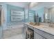 Bright bathroom with double vanity, soaking tub, and elegant marble accents at 1217 Reunion Village Blvd, Kissimmee, FL 34746