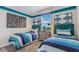 Charming bedroom featuring twin beds, tasteful decor, and a bright, airy feel at 1217 Reunion Village Blvd, Kissimmee, FL 34746