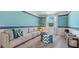 Cozy bonus room with a comfy sectional, colorful decor, and lots of natural light at 1217 Reunion Village Blvd, Kissimmee, FL 34746