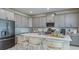 Bright kitchen with modern gray cabinets, stainless appliances, and large island at 1217 Reunion Village Blvd, Kissimmee, FL 34746
