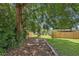 Large, shaded backyard with a new fence providing privacy and a well-maintained lawn at 1301 Lawne Blvd, Orlando, FL 32808