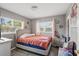 Relaxing bedroom with two bright windows, soft lighting, and wood-look floors at 1301 Lawne Blvd, Orlando, FL 32808