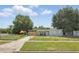 Charming single-story home featuring a fenced yard, picnic table, and cozy outdoor space at 1301 Lawne Blvd, Orlando, FL 32808