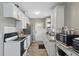 Well-lit kitchen with granite counters, modern appliances, and ample white cabinets at 1301 Lawne Blvd, Orlando, FL 32808