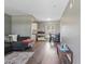 Open-concept living room with wood floors flowing into the dining area and bright kitchen at 1301 Lawne Blvd, Orlando, FL 32808