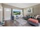 Inviting living room with a large window offering scenic views, plush seating, and wood-look floors at 1301 Lawne Blvd, Orlando, FL 32808