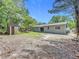 Expansive backyard featuring a storage shed, partial fencing, and plenty of space for outdoor activities at 1307 Jean Ct, Eustis, FL 32726