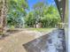 Large backyard surrounded by mature trees and partial fencing. Features two storage sheds at 1307 Jean Ct, Eustis, FL 32726