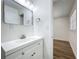 Modern bathroom features a white vanity with modern fixtures, and a view into bedroom at 1307 Jean Ct, Eustis, FL 32726